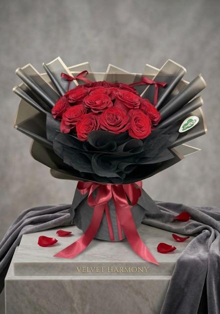 Red rose bouquet in black wrapping with a red ribbon